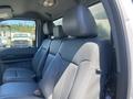 A 2015 Ford F-450 SD featuring a spacious interior with gray leather seats and headrests in a crew cab configuration