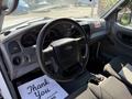 Interior of a 2009 Ford Ranger showing the steering wheel dashboard and front seats with a floor mat that says Thank You