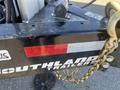 2024 Southland 18 Foot Dump Trailer featuring branding and a red and white DOT compliance label with a gold chain attached to the hitch