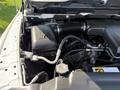 View of the engine compartment of a 2019 RAM 1500 Classic showing the air intake, engine components, and hoses