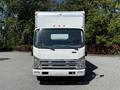 A white 2007 GMC W3500 box truck with a large cargo area and open side doors facing forward