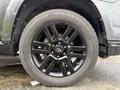 A close-up view of a black alloy wheel with a Toyota emblem featuring a Yokohama tire with visible tread patterns