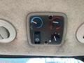 Dashboard control panel for climate and ventilation in a 2014 John Deere 1585 Terrain Cut featuring knobs for temperature and fan settings