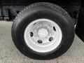 Close-up of a Yokohama tire mounted on a white wheel with a five-bolt pattern and visible tread design from a 2022 Isuzu NPR