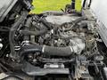 View of the engine compartment of a 2018 Isuzu NRR showing the engine and various components without the outer casing