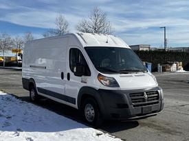 A white 2017 RAM Promaster van parked with snow on the ground featuring a high roof and large cargo area