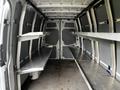 Interior of a 2016 Mercedes-Benz Sprinter van featuring two metal shelves along the sides of the cargo area