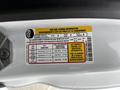 Tire and loading information label on a 2023 Ford Transit showing seating capacity and recommended tire pressure for front and rear tires