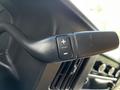 Close-up of a steering wheel control lever with plus and minus buttons in a 2017 GMC Savana van