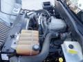 View of the engine compartment of a 2014 International Durastar featuring various hoses wires and engine components with a translucent coolant reservoir