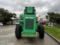A green 2014 JLG 10054 telehandler with large tires and a raised mast labeled Skytrak