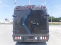 A black 2016 Ford Transit van with a textured rear door and distinctive chevron pattern in blue and gray on the back