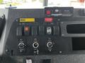 Dashboard of a 2009 Spartan Gladiator featuring various switches and controls including lights ignition and power outlets
