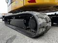 Close-up of the heavy-duty rubber track of a 2024 Caterpillar 306 excavator showcasing the tread pattern and roller system