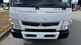 A 2018 Mitsubishi Fuso FE160 with a white exterior featuring a prominent front grille and headlights