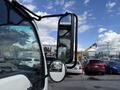 A 2007 GMC W5500 18 Foot Cube Van with a side mirror visible in the foreground and part of the cab shown