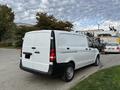 A white 2019 Mercedes-Benz Metris van viewed from the rear with a simple and functional design showcasing its cargo area and sliding side door