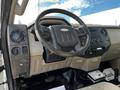 Interior view of a 2008 Ford F-550 showing the steering wheel dashboard controls and gear shift