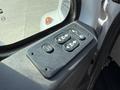 Close-up of a control panel with buttons for door operation and window locking on a 2009 International 7500 truck