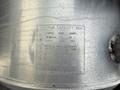 A metal fuel tank with a label indicating maximum capacity and details about fuel requirements and specifications