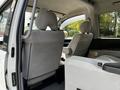 A 2003 Mitsubishi 7 Passenger Van interior showing two fabric-covered front seats and a view of the passenger compartment with seatbelts visible