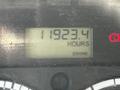 A digital display showing 11923.4 hours with an engine indicator light on a 2004 Freightliner M2 dashboard