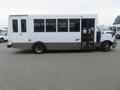 A 2020 Chevrolet Express bus with a white exterior and large windows on the side