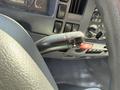 Close-up of the steering wheel of a 2013 Isuzu NPR featuring the turn signal and windshield wiper controls on the left side