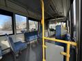 Interior view of a 2016 Grande West Vicinity bus featuring blue upholstered seats and yellow handrails in an empty cabin