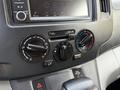 Control panel of a 2021 Nissan NV200 showing climate controls and audio system with knobs and buttons for various settings