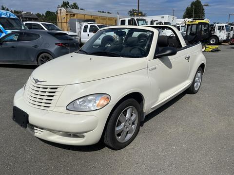 A white 2005 Chrysler PT Cruiser convertible with a black interior parked on a gravel surface