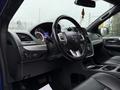 Interior view of a 2020 Dodge Grand Caravan featuring a steering wheel dashboard and center console with controls and gauges