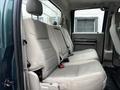 The image shows the rear interior of a 2008 Ford F-550 with light grey fabric seats and seat belts visible
