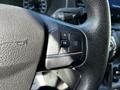 A close-up of the steering wheel controls in a 2022 Ford Transit featuring buttons for navigation and settings