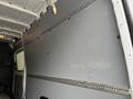 Inside of a 2019 Mercedes-Benz Sprinter with a gray panel wall and metal railings for securing cargo