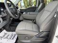 Interior view of a 2024 Ford F-550 showing the front driver's seat with gray upholstery and a console between the seats