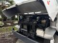 A 2018 Ford Econoline with its hood open revealing the engine compartment and key components such as the battery and cooling system