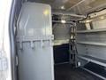 Interior of a 2016 Ford Transit showing storage shelves and a partition wall
