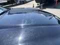 A shiny black 2019 Dodge Charger hood displaying light scratches and reflections under sunlight