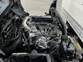 A 2018 Hino 195 engine shown in the foreground with visible components including hoses wires and a metallic structure
