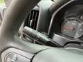 Close view of the steering wheel and dashboard of a 2016 GMC Sierra 1500 showing the turn signal lever and speedometer