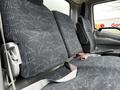 The interior of a 2013 Hino 195 featuring a gray upholstered bench seat with seatbelts and ergonomic backrests