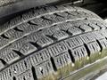 Close-up of a tire from a 2015 Chevrolet Express showing distinct tread patterns and some wear on the surface