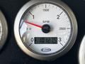 Close-up of a tachometer gauge displaying RPM readings from 0 to 2500 with a digital odometer showing 101275 on a dashboard of a fire truck