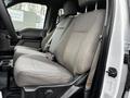 A gray fabric seat inside a 2017 Ford F-550 with a high back and armrests visible