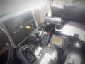 Interior view of a 2016 International WorkStar 7500 featuring a dashboard with control buttons a touchscreen display and various gauges