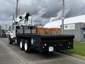 A 2008 International 7500 truck with a flatbed and a mounted crane on the back