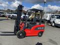 A red 2024 AGT KFE20 forklift with a black seat and a vertical lifting mechanism