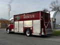 A red 1994 Freightliner FL80 rescue truck with shiny metal panels and the word RESCUE displayed prominently on the side