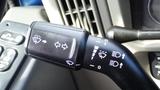 A close-up of a turn signal and wiper control stalk from a 2012 International DuraStar 4300 with various symbols for functions like headlights and windshield wipers